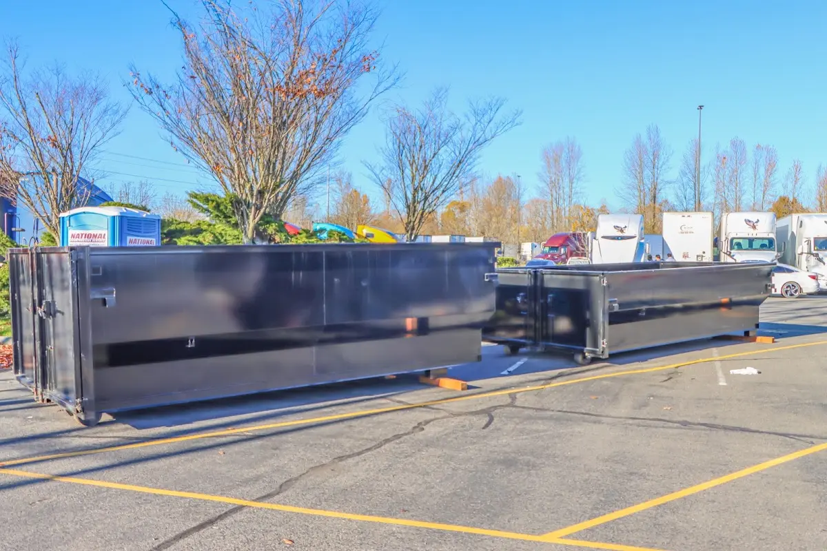 Professional dumpster rental service with roll-off container on residential driveway in Pennsville